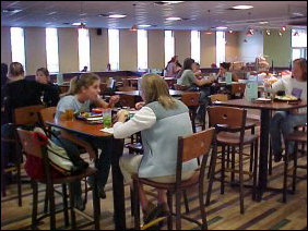 In the former dining room #4, in the middle of the room are raised tables, and further back, half-booths, four-seat tables, and eight-seat tables.