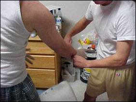 Afterwards, Patrick helps Joe into the gloves for phase two... rinsing the stuff out.