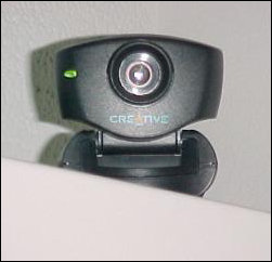 The Web Cam is perched on top of the computer this year, and faces the opposite direction from last year. Now viewers can see the left side of my face on the camera!