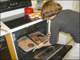 Meanwhile, while we were waiting for the flames to die down, Maggie took the hamburgers inside and tried to broil them in the oven. It was a valiant try, but all that managed to do was smoke up the kitchen and set the smoke detector off.