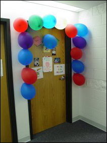 In celebration of a birthday, a door is decorated with balloons!