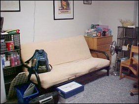 On the other side of the room, the futon is back in action, as well as the refrigerator and various supplies.