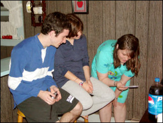 Kathleen shows Josh and Maggie the Taizé CD, and then starts it playing. It should be noted that we do some of our Wednesday worship services Taizé style.