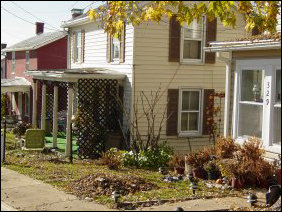 Most of the Old High Street neighborhood is single-family residential (above), though there is some high-density residential (below left), consisting of apartments where parking has replaced the front yard, and also medium-density residential (below right), in the case of this duplex where there is a couch in front of one of the entrances (strange, don't you think?).