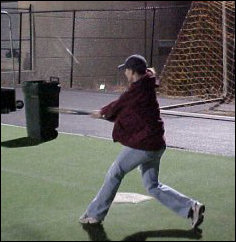 Becky nails a ball with amazing speed!  If you look straight up the picture from the bat, you'll kind of be able to see the ball, going up and away relative to Becky.