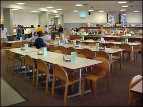 Dining Room #3 has large, comfortable wooden chairs at the tables, and a nice view out the window towards Zane Showker Hall.