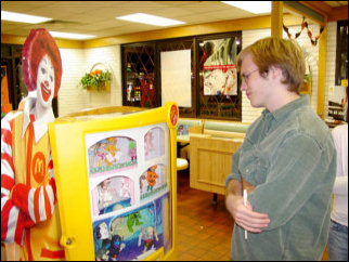 Meanwhile, Spencer ponders the navel of the universe while looking at the Happy Meal toys.