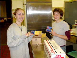 Mary and Maggie strike a "cheesy" pose while helping prepare the food for lunch.