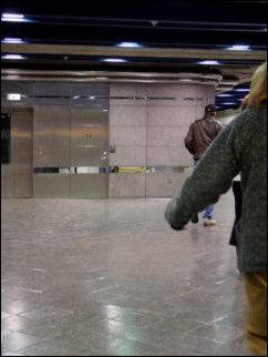 Inside some of the underground stations, passengers disembark, and trains sit idle on a side track.